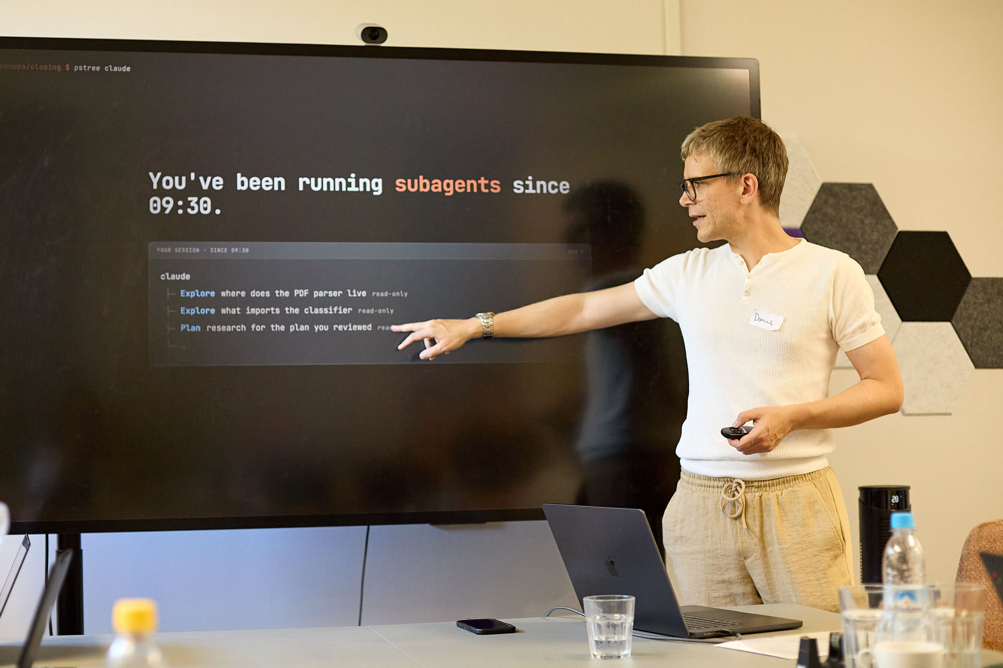 Dominik Grusemann points at a slide reading 'You've been running subagents since 09:30' at the planqc workshop